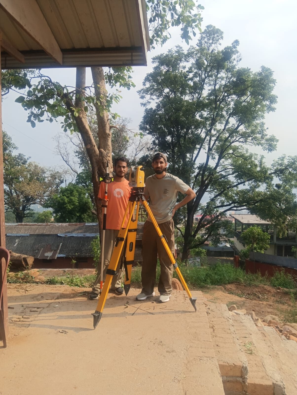 EDMRC building-assessment team with total station survey instrument