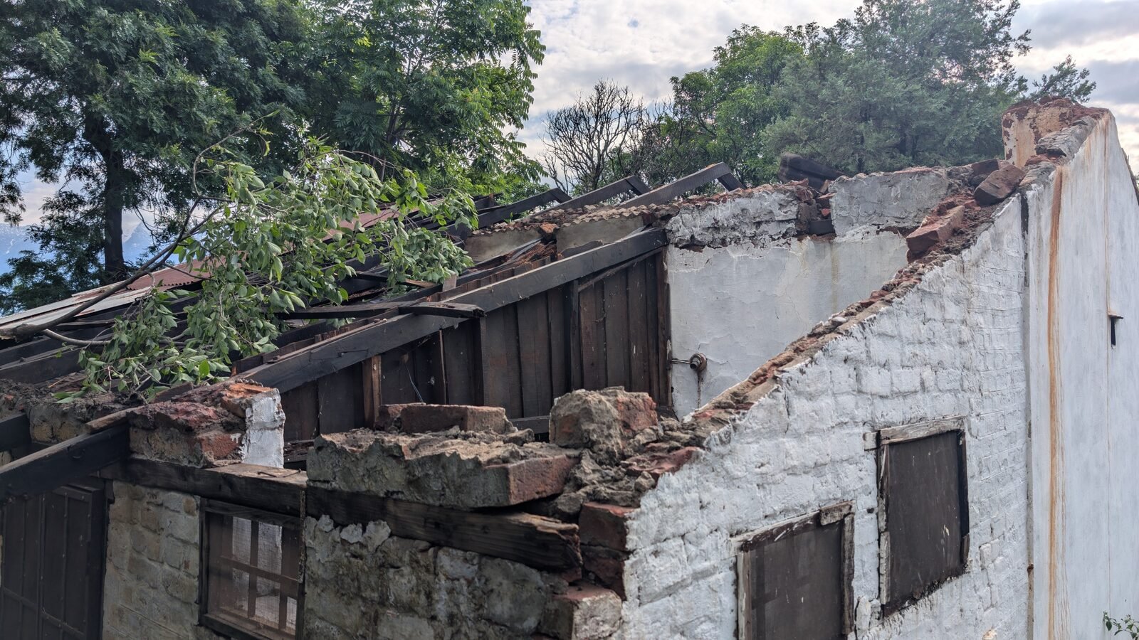 Detailed inspection of structural damage — corner masonry failure