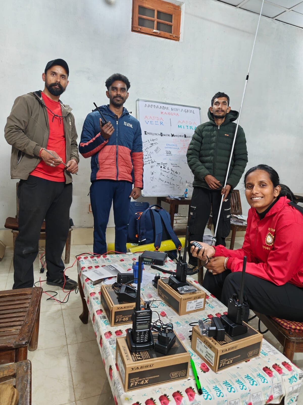EDMRC Kangra Amateur Radio Club (VU2EDM) team members with Yaesu FT-65 and FT-4X dual-band transceivers